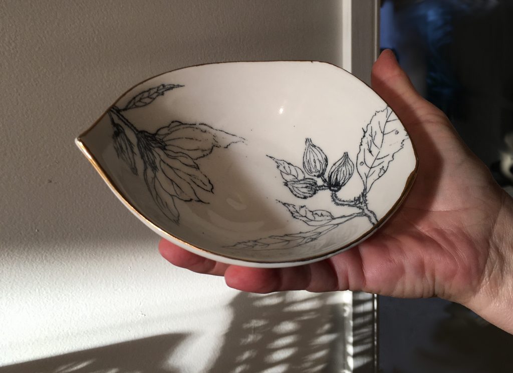 Porcelain with hand drawn decal and gold lustre edge by Simon Suckling